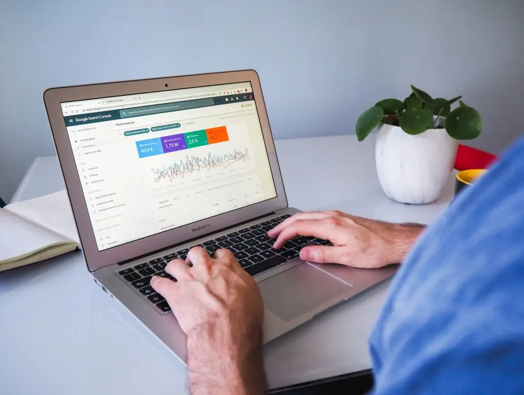 A person using a laptop with Google ads dashboard open for PPC advertising